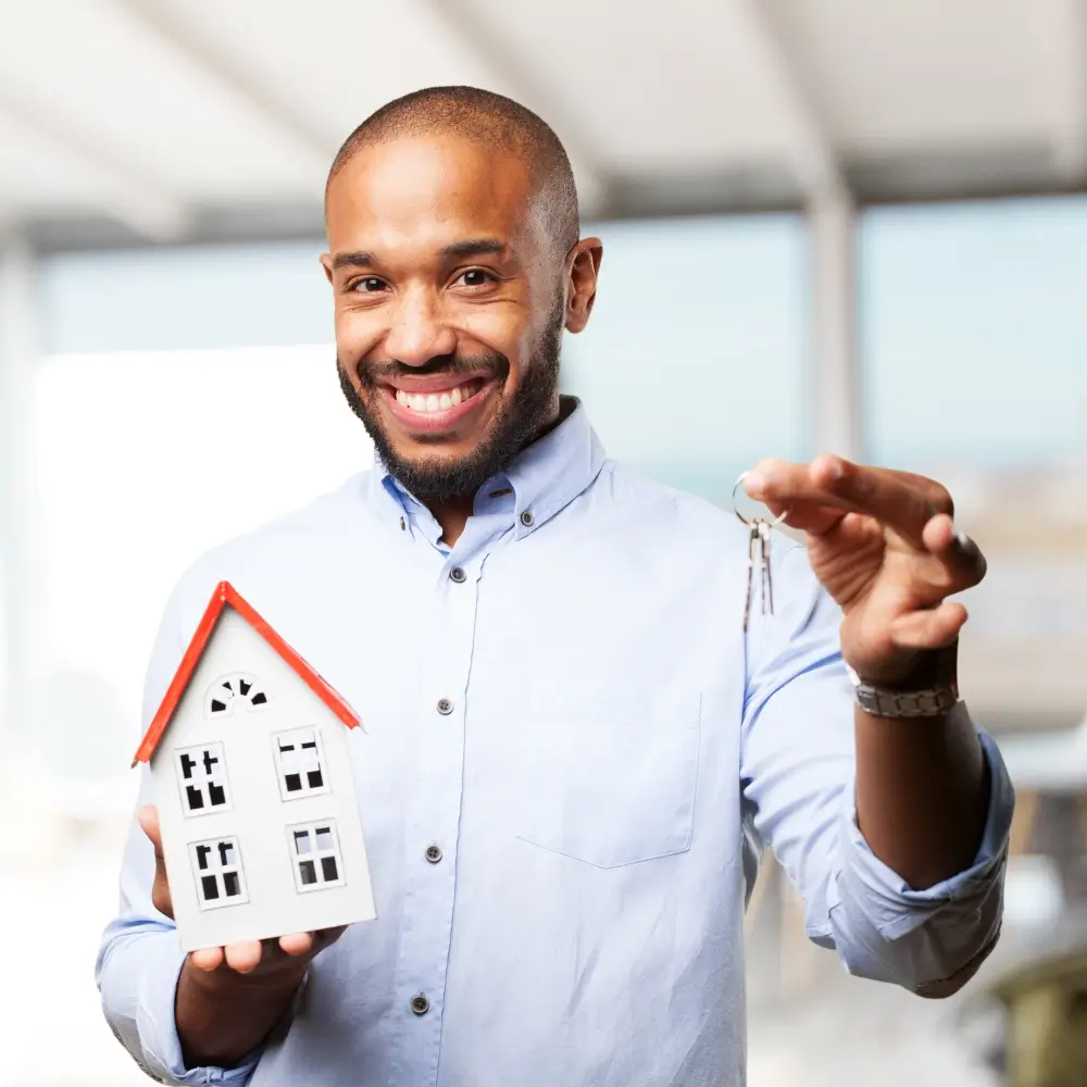 Man holding keys to a house in his hand